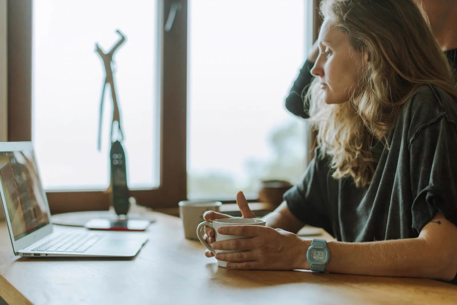 Small business owner focused on creative work while AI agents handle admin in the background